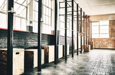 Equipment, pull up bars and fitness in gym floor for exercise, workout and bodybuilding or health. Wellness, jump or plyo boxes in training centre for sports, muscle and power with no peopleの写真素材