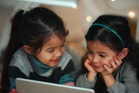 Sisters, home and children in bed with tablet for streaming animation movies, educational cartoon...