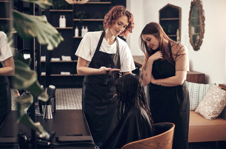 Salon, haircut and teamwork with girl, customer and hair for grooming or wellness. Beauty, client and scissors with creative style, beautician at work with employee for startup haircare serviceの写真素材