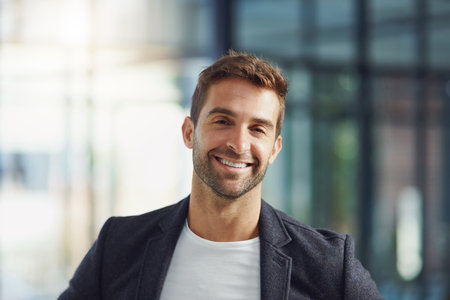 Business man, portrait and happy in office for company, trust and about us with smile as expert. Financial advisor, face and professional person at workplace for growth with experience or knowledgeの写真素材