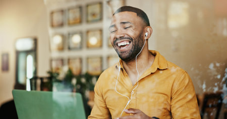 Man, cafe and happy on laptop with video call for communication and networking as restaurant manager. Entrepreneur, virtual meeting and laughing or smile on webinar or conference with good newsの写真素材