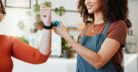 Person, smart watch and nfc to pay in coffee shop for sale or exchange, ecommerce and digital checkout. Woman, waiter and cafe with technology for internet banking, payment and online transaction.の写真素材