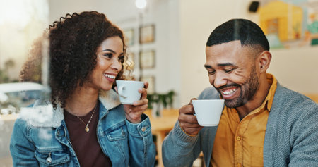 People, couple and bonding for coffee date in cafe for romance, love and support with care. Relationship, lovers and happy or smile at restaurant for fun, conversation and drinking tea on breakの写真素材