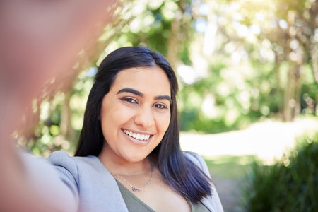 Business woman, selfie and smile in park with portrait, memory and outdoor in sunshine for post on...