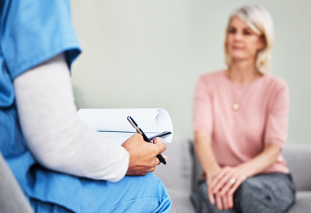 Nurse, paperwork and woman patient in hospital with writing prescription, information and advice for help of medical treatment. Healthcare, document and test results with records of health historyの写真素材