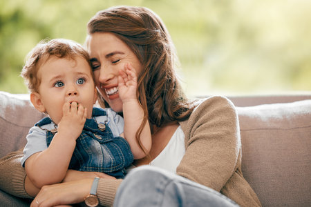 Mother, baby and hug in home for childcare, love and support kid for development or growth in lounge. Mommy, son and embrace for safety in relationship, happy and relax on couch together for bondingの写真素材
