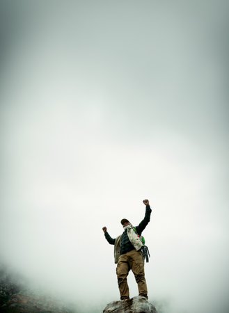Space, mountain peak or man with hiking success in outdoor adventure celebration in nature for travel. Success, low angle and excited person on hill for winning, achievement or trekking on sky mockupの写真素材