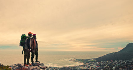 Sunset, ocean or people on mountain peak hiking in outdoor adventure or journey in nature for travel. Evening, wellness and friends on trail walking for holiday, break or trekking to explore for viewの写真素材