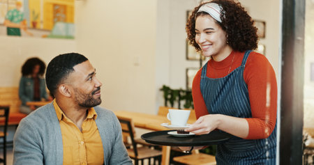 Hospitality, man and waitress in cafe with drink, client order and smile at table. Barista woman, male customer and service in restaurant for latte, small business and local support in coffee shopの写真素材