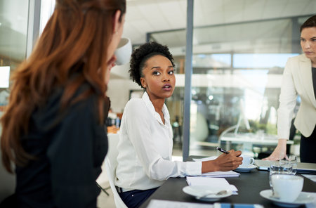 Businesswoman, meeting and leadership in office for discussion, collaboration and strategy or plan. Female executive, notes and women in boardroom for team building, brainstorming and reviewの写真素材