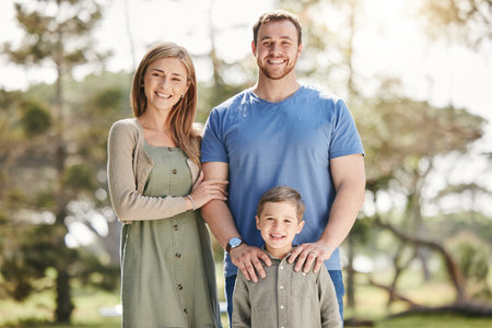 Happy, nature and portrait of parents with child at National park for adventure on family holiday. Smile, hugging and boy with mother and father in outdoor field for bonding on vacation in Californiaの写真素材
