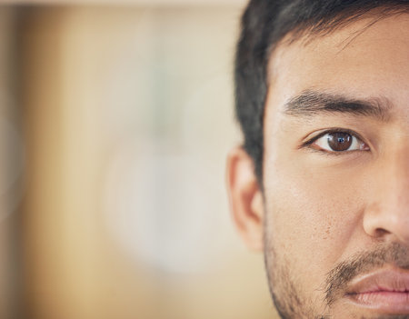 Closeup, serious and half face of man with advertising mockup, skincare and thinking for skin health. Portrait zoom, Asian guy and banner for dermatology thoughts with natural glow and beauty ideasの写真素材