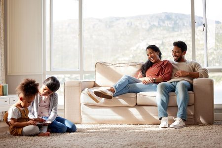 Parents, children and playing with tablet on floor for online games, bonding and educational video in home. Happy family, people and digital tech on carpet for watching movies, fun cartoons and loveの写真素材