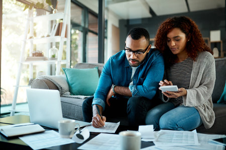 Calculator, budget checklist or couple writing with financial paperwork, notes or planning savings. Accounting, investment or people organizing bills for paying debt, finance or household expensesの写真素材