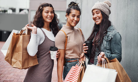 Happy women, shopping bag or portrait in city for bonding, support or outdoor travel together. Sisters, trip or girls ready for sale, boutique discount or holiday with fashion, smile or style in townの写真素材