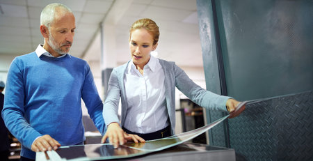 Man, woman and printing in factory with check, creative manager or designers with teamwork. Business...