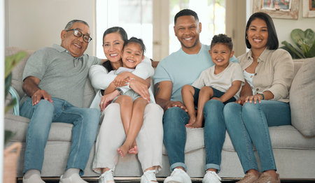 Happy family, relax and portrait for reunion on sofa in living room for gathering, together and love. Support, children and excited for holiday or vacation in home with kid and grandparents on couchの写真素材