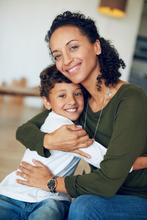 Happy, boy and mother hugging portrait with love, bonding and together for relationship with caring embrace. Relaxing, family and apartment for childcare or parent, affection and kid smiling in houseの写真素材
