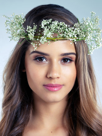 Woman, portrait and flower crown for beauty, skincare and organic for wellness on white background. Smile, wreath and natural cosmetics for female model person, studio and grooming for cosmetologyの写真素材