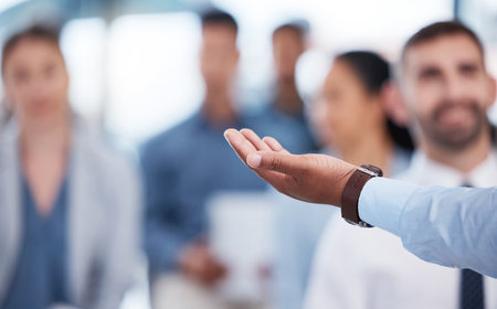 Hand, person and presentation for group of business people with choice, information or training in office. Palm, speaker and tradeshow with audience, brainstorming or discussion at corporate workshopの写真素材