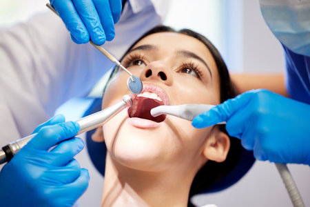 Face, hands and surgery with woman at dentist for oral hygiene or dental care appointment closeup. Healthcare, medical and mirror with patient in chair at clinic for mouth checkup or cleaningの写真素材