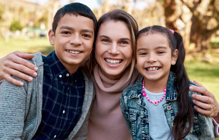 Park, mother and kids in portrait as family, bonding and spend time together with smile. Happy people, mom or parent with children outdoor in nature for relaxing, recreation or physical activityの写真素材