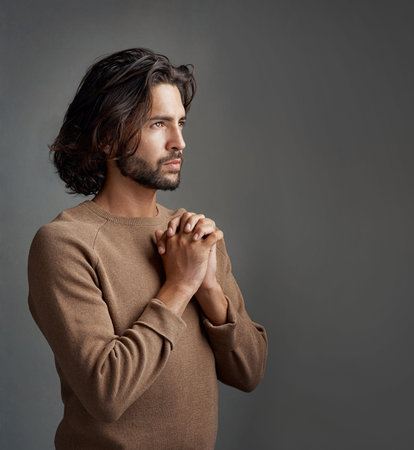 Gratitude, man and praying with faith, spiritual and person on grey studio background. Believe,...