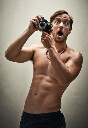 Man, portrait and vintage camera for shirtless photo in studio, wow and shocked for photography. Male person, lens and surprise for image or picture, topless and abs for memory or shooting torsoの写真素材