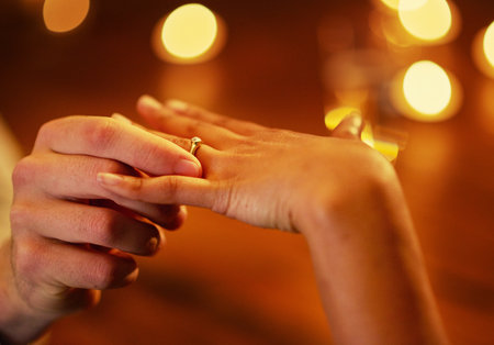 Hands, couple and engagement ring for proposal with fiance for love with commitment, people and unity. Romantic, surprise and special moment with save the date or flare, relationship and together.の写真素材