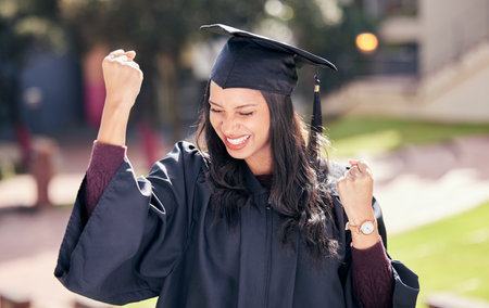 Success, smile and woman celebrate graduation, achievement or winning at college campus. Yes, cheers and happy graduate outdoor at university for education goal, scholarship and victory of studentの写真素材