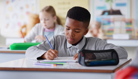 African boy, writing and test in classroom for learning, knowledge and info for assessment at youth academy. Child, paper and education with scholarship, studying and exam for development at schoolの写真素材
