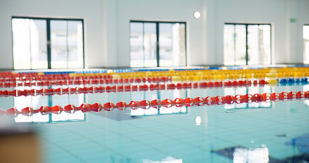 Swimming pool, empty and lines with game, competition and water for sports, cardio workout and dividers. Fitness, blue and swim training arena ready for race performance, lanes and exercise challengeの写真素材