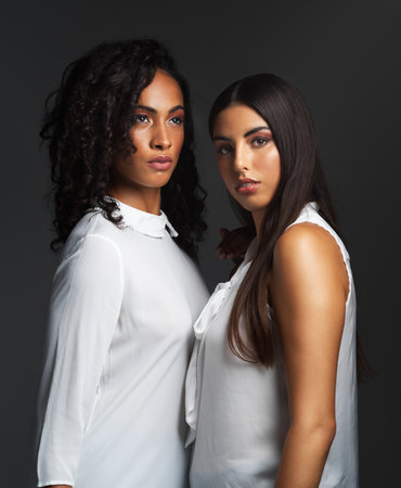 Business people, portrait and serious in studio as women for partnership career on black background. Cosmetic industry, face and teamwork as beauty for makeup artist, facial and skin treatmentの写真素材