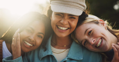 Girl, friends and happy with portrait in park for bonding, embrace and summer adventure with lens flare. Woman group, people and smile outdoor in nature with relax, holiday and caring with vacationの写真素材