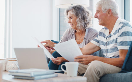 Paperwork, old couple and reading for retirement, laptop and financial report of senior people and...