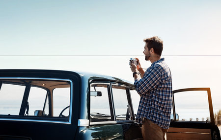 Man, camera and photography with car outdoor for travel view, road trip journey and vacation adventure of memory. Man driver, digital gear and transport vehicle, parking and location scenery of peaceの写真素材