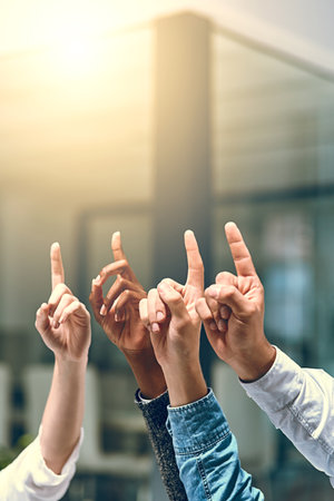 Business people, fingers and crowd asking in office, feedback and emoji for brainstorming vote. Employees, corporate training and hand up for problem solving or solution, workshop and staff opinionの写真素材