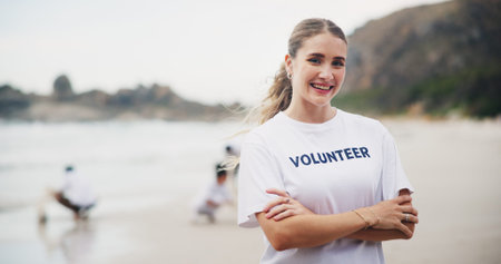 Girl, charity and volunteer at beach for cleaning, recycling and environment sustainability with...