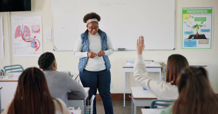 Teacher, question and student in college, education and preparing for exam in classroom, learning and hand. Answer, person and arm up for feedback of professor, knowledge and listening in universityの写真素材