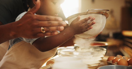 Education, girl and hands in kitchen for baking, recipe or sifting organic flour at home. Child,...