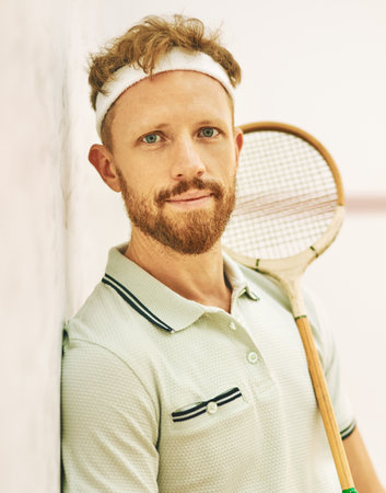 Exercise, portrait and racket with squash player man on wall background in gym for competition or game. Fitness, training and workout with face of sports person on court for match or tournamentの写真素材