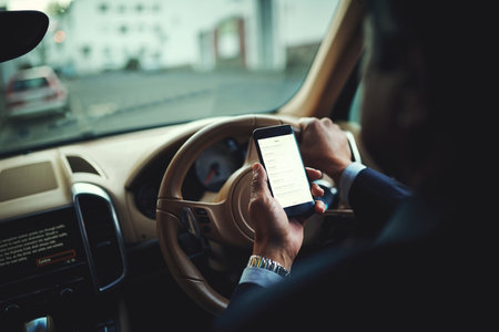 Man, cellphone and digital map with driving car, commute and steering wheel or route for business trip in transport. Navigation screen, back view and driver hands for journey and luxury vehicleの写真素材