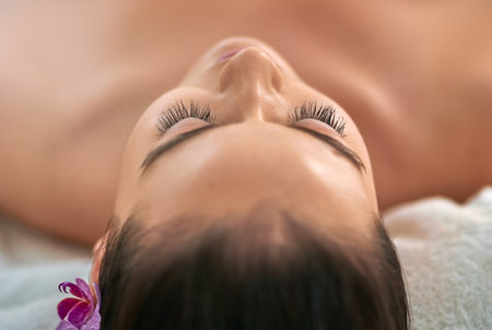 Peace, relax and woman with massage at spa for cosmetic, beauty or luxury treatment on holiday. Zen, client and female person with self care at resort for holistic healing, service or health benefitsの写真素材