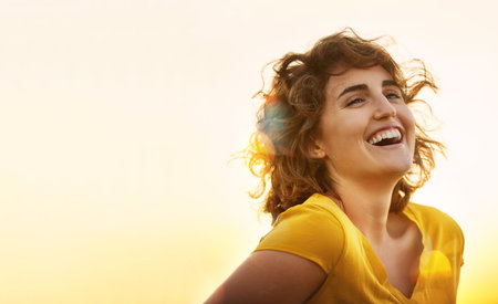 Happy woman, laughing and summer with sunset for holiday, travel or outdoor weekend in nature. Young female person with smile and enjoying sunshine or natural environment for freedom on mockup spaceの写真素材