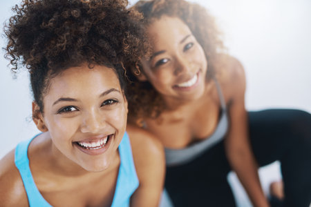 Portrait, relax and women on yoga class break for support, wellness or rest for health together. Above of face, confident or happy friends with pride, teamwork or smile in pilates studio for progressの写真素材