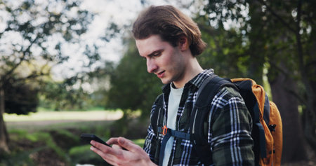 Hiking, phone and man in nature for directions, navigation app and checking route on map. Lost, low...