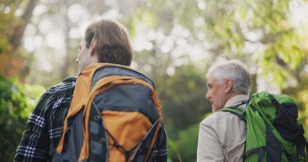 Father, son and fitness for hiking outdoor with backpacking support, trekking adventure and morning...