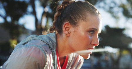 Outdoor, tired and rest of woman for fitness, exercise and break after running in marathon...
