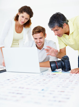 Business team, laptop and meeting with camera for startup photography company and people in office. Entrepreneur, technology and photographer with collaboration for media, film or digital projectの写真素材