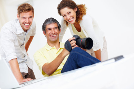 Team, photographers and portrait in office for art, review camera picture and creative session....